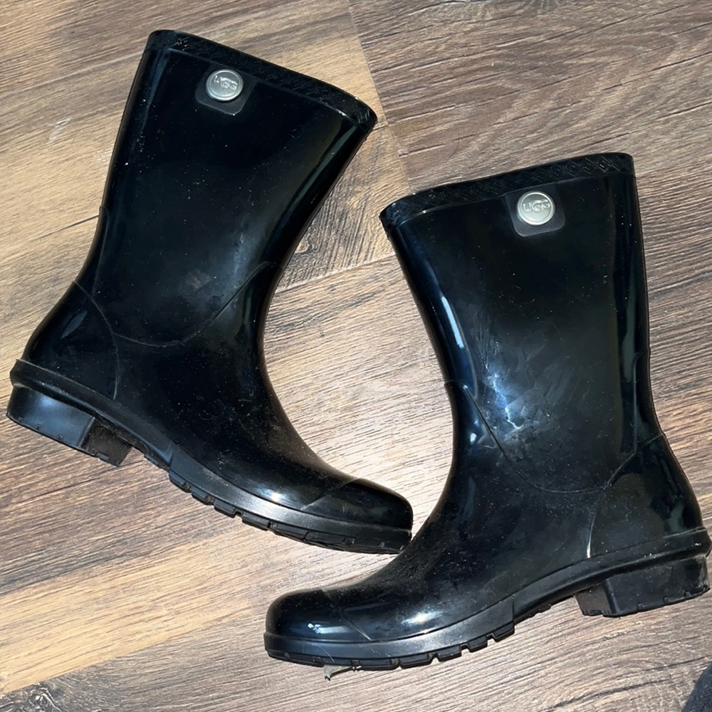 All black UGG rain boots with a fuzzy foot sole